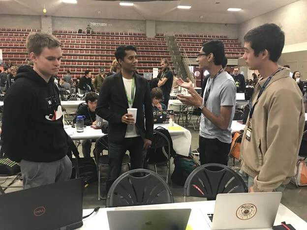 Chander Dhall judging students at MIT